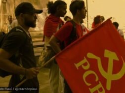 Grupo de jovens militantes da UJC no Piauí em ato público, com uma bandeira vermelha do PCB em destaque, em ambiente ao ar livre.