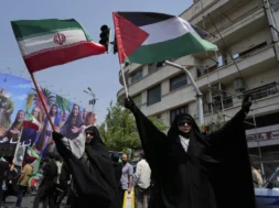 Manifestantes iranianos levantam bandeiras do Irã e da Palestina em um ato contra Israel em Teerã, Irã, na sexta-feira, 13 de junho de 2025. (AP Photo/Vahid Salemi)